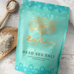 Zaytoun Dead Sea Bath Salts 750g, in a light blue packet with the sea salts on a wooden board, and in a wooden spoon