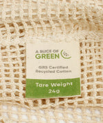 A close up view of the A Slice Of Green small mesh recycled cotton produce bag showing the mesh detail. Features a tag showing the total carry weight and recycled cotton certification 
