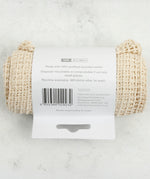 Back view of the A Slice Of Green large mesh recycled cotton produce bag laid flat on a stone surface. Comes in a plastic free packaging band showing the bag size, how to dispose and recycled cotton certification. 