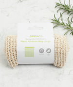 A Slice Of Green large mesh recycled cotton produce bag laid flat on a stone surface. Comes in a plastic free packaging band