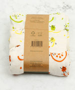 A Slice Of Green set of 3 organic cotton muslin cloths in rainbow inspired designs. Comes in a recycled cardboard band. 