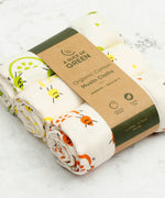 A close up of the A Slice Of Green rainbow muslin cloth set showing the fruit print detail on organic cotton fabric. 