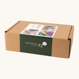 Set of 72 Abel curved wooden blocks in rainbow colors, including yellow, orange, red, purple, blue and green in their cardboard packaging box.