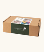 Set of 72 Abel curved wooden blocks in rainbow colors, including yellow, orange, red, purple, blue and green in their cardboard packaging box.