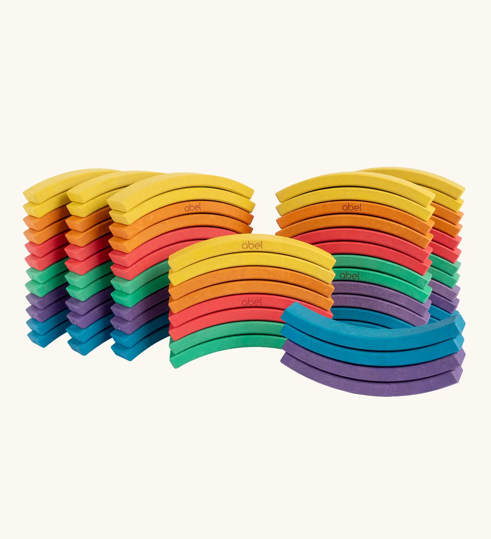 Set of 72 Abel curved wooden blocks in rainbow colors, including yellow, orange, red, purple, blue and green placed in stacks. 12 blocks in each colour. 