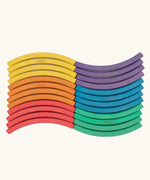 Set of 24 Abel curved wooden blocks in rainbow colors, including yellow, orange, red, purple, blue and green arranged in a wavy pattern. Four blocks in each colour.