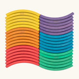 Set of 36 Abel curved wooden blocks in rainbow colors, including yellow, orange, red, purple, blue and green arranged in a wavy pattern. 6 blocks in each colour. 