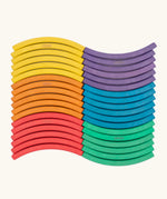 Set of 36 Abel curved wooden blocks in rainbow colors, including yellow, orange, red, purple, blue and green arranged in a wavy pattern. 6 blocks in each colour. 