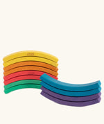Set of 12 Abel curved wooden blocks in rainbow colors, including yellow, orange, red, purple, blue and green shown stacked.