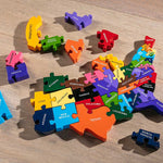 Alphabet Jigsaw sustainable multicoloured Map of America puzzle toy laid out on a wooden floor