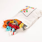Alphabet Jigsaw wooden Rocket Number pieces pouring out of a white drawstring bag on a white background
