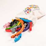 Alphabet Jigsaw handmade Rainbow arch children's puzzle pieces pouring out of a white drawstring bag on a white background