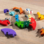 Alphabet Jigsaw eco-friendly multicoloured rainbow Rocket puzzle pieces laid out on a wooden background