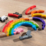 Alphabet Jigsaw sustainable coloured wooden Rainbow jigsaw game laid out on a wooden floor background