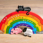 Alphabet Jigsaw plastic-free wooden Rainbow puzzle toy stood up on a wooden floor background