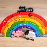 Alphabet Jigsaw plastic-free wooden Rainbow puzzle toy stood up on a wooden floor background