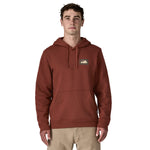 A man wearing the Patagonia Fitz Roy uprisal adult hoody in dried vanilla colour available at Babipur.
