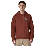 A man wearing the Patagonia Fitz Roy uprisal adult hoody in dried vanilla colour available at Babipur.