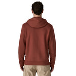 The back of a man wearing the wearing the Patagonia Fitz Roy uprisal adult hoody in dried vanilla colour available at Babipur.