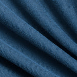 An adults hands are slightly stretching an Aura Wrap to show the texture and material