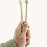 Wooden and rubber mallet for the Auris 3 tone glockenspiel held by a adult hand showing size 