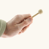 Small wooden mallet for the Auris junior glockenspiel held by a adult hand showing size 
