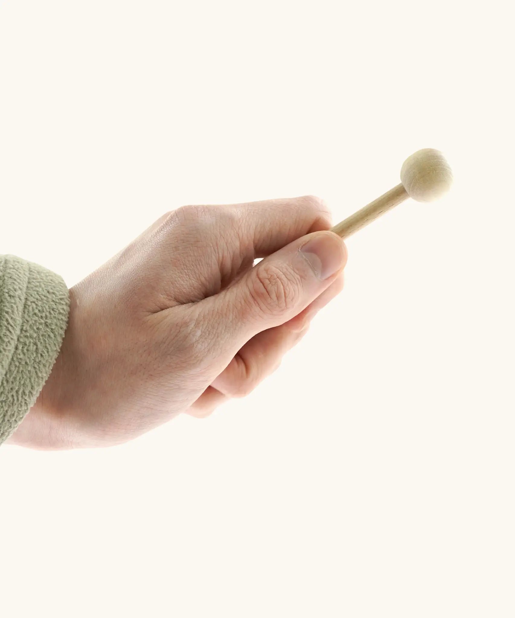 Small wooden mallet for the Auris junior glockenspiel held by a adult hand showing size 