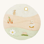 A wild chamomile Avery Row activity play mat with a rabbit, carrot a teacup and flower on top of the play mat on a cream background.