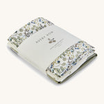 A soft Avery Row muslin sqauare set of 3 including a flower design, light  and a green muslin square on a cream background