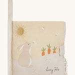 A soft beige Avery row baby book with a rabbit on the cover on a cream background.