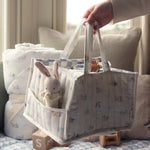 A person taking out a white and blue checked cloth from the Avery Row Organic Cotton Nappy Caddy Organiser - Coastlines