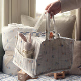 A person taking out a white and blue checked cloth from the Avery Row Organic Cotton Nappy Caddy Organiser - Coastlines