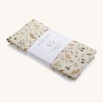 A light cream Avery Row long changing cushion cover with a grassland design on a cream background.