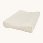 A Avery row changing cushion with a daisy flower design on a cream background.