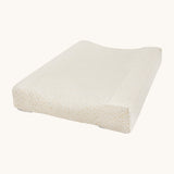 A Avery row changing cushion with a daisy flower design on a cream background.