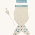 A light Avery row mermaid dress up set with a light blue trim including a light blue crown and a light shell wand on a cream background.