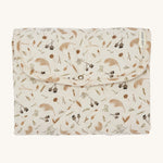 A light soft cream Avery Row travel changing mat with a grassland design on a cream background.