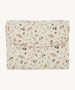 A light soft cream Avery Row travel changing mat with a grassland design on a cream background.
