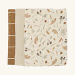 Soft Avery Row muslins set of 3 including a light cream and grassland muslin, a light beige muslin and a brown with white stripe muslin on a cream background.