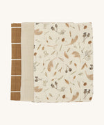 Soft Avery Row muslins set of 3 including a light cream and grassland muslin, a light beige muslin and a brown with white stripe muslin on a cream background.