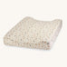A soft light coloured Avery Row changing cushion mat with a grasslands design on a cream background.