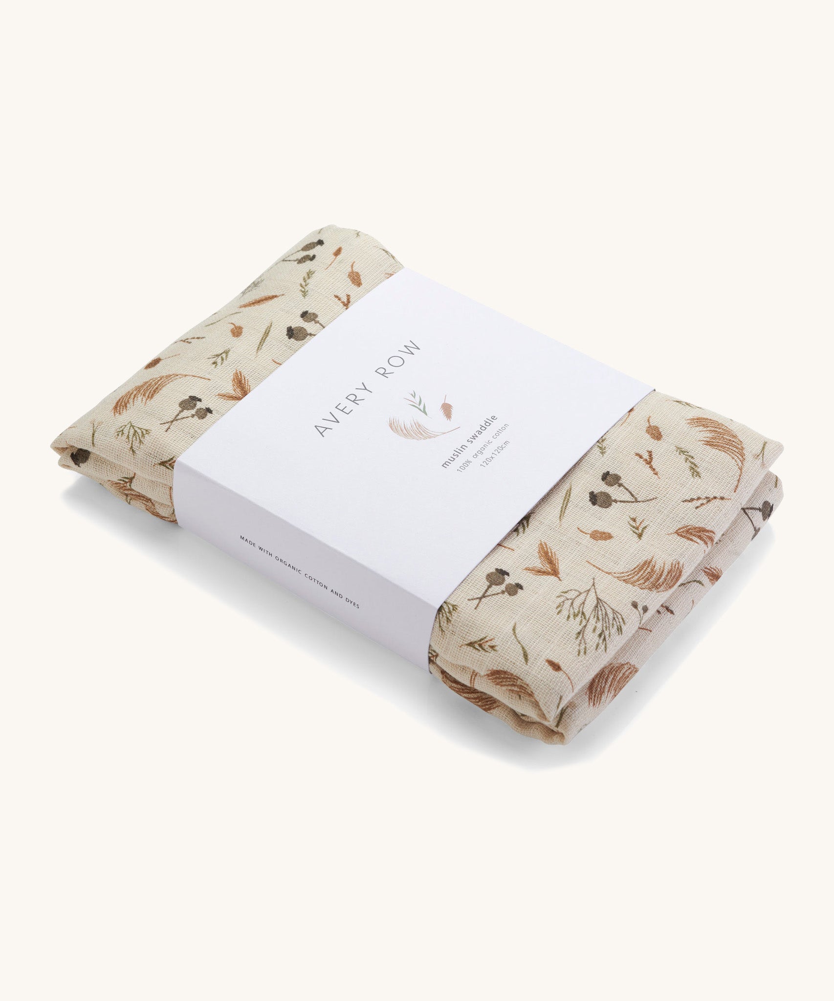 A light cream Avery Row muslin swaddle with a grassland design on a cream background.