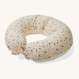 A soft light cream Avery Row nursing pillow with a grassland design on a cream background.