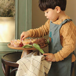 Avery Row Kid's Apron - Forest Bear. A beautiful blue cotton canvas apron with a detailed