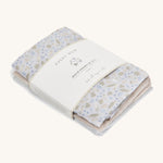 A soft Avery row muslin squares set of 3 including a light blue with a nature design, beige and light blue muslins on a cream background.