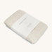 A Avery row muslin swaddle with a daisy flower design on a cream background.