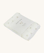 A soft light coloured Avery Row muslin square with a nettle design on a cream background.
