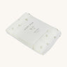 A soft light coloured Avery Row muslin square with a nettle design on a cream background.