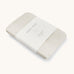 A Avery row muslin swaddle with a wild chamomile design on a cream background.