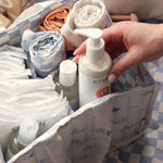  above a checked white and blue blanket and wooden blocks